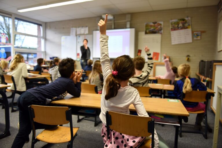 Lively classroom scene with students participating acti