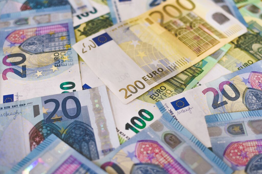 Close-up of various Euro banknotes scattered on a surfa